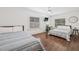 Bright bedroom with two beds, hardwood floors, and large windows at 7708 N Arden Ave, Tampa, FL 33604