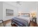 Bright bedroom showcasing hardwood floors, a ceiling fan, and natural light through a window at 7708 N Arden Ave, Tampa, FL 33604