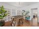 Well-lit game room featuring a foosball table, built-in bookshelves, hardwood floors, and plant decor at 7708 N Arden Ave, Tampa, FL 33604