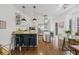 Bright, updated kitchen with a kitchen island, pendant lighting, stainless steel appliances, and adjacent dining area at 7708 N Arden Ave, Tampa, FL 33604