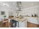 Bright kitchen with stainless steel appliances, center island with seating, and granite countertops at 7708 N Arden Ave, Tampa, FL 33604