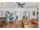 Inviting living room featuring hardwood floors, ceiling fan, and stylish decor at 7708 N Arden Ave, Tampa, FL 33604