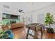 Open living space showcasing hardwood floors, a foosball table, and views of the fireplace and front door at 7708 N Arden Ave, Tampa, FL 33604