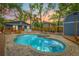Stunning backyard features a sparkling pool, spa, and inviting seating areas for relaxation at 7708 N Arden Ave, Tampa, FL 33604