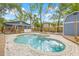 Stunning backyard features a sparkling pool, spa, and inviting seating areas for relaxation at 7708 N Arden Ave, Tampa, FL 33604
