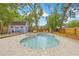 Backyard features a luxurious pool, spa, and outdoor seating areas for relaxation and entertainment at 7708 N Arden Ave, Tampa, FL 33604