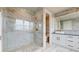 A sleek bathroom boasting a glass shower, marble accents, and modern vanity at 772 Gran Kaymen Way, Apollo Beach, FL 33572