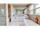 A modern bathroom with marble tile, double sinks, and a soaking tub at 772 Gran Kaymen Way, Apollo Beach, FL 33572
