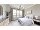 A cozy bedroom with a large window, hardwood floors, and natural decor at 772 Gran Kaymen Way, Apollo Beach, FL 33572