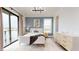 Bright bedroom featuring a balcony, stylish decor, and serene blue accent wall at 772 Gran Kaymen Way, Apollo Beach, FL 33572