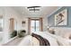 A modern bedroom with a balcony, decor, and soft, neutral tones at 772 Gran Kaymen Way, Apollo Beach, FL 33572