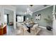 Stylish dining room with modern lighting, adjacent to a comfortable seating area at 772 Gran Kaymen Way, Apollo Beach, FL 33572