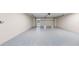 Spacious garage with speckled floor and overhead door at 772 Gran Kaymen Way, Apollo Beach, FL 33572