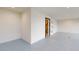 Spacious garage with speckled floor and access to stairs at 772 Gran Kaymen Way, Apollo Beach, FL 33572