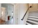 Hallway view showcasing the staircase and entryway to the powder room and living area at 772 Gran Kaymen Way, Apollo Beach, FL 33572
