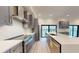 Modern kitchen with stainless steel appliances, gray cabinets, quartz countertops, and efficient design at 772 Gran Kaymen Way, Apollo Beach, FL 33572