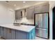 Modern kitchen features gray cabinets, stainless steel appliances, and a spacious island at 772 Gran Kaymen Way, Apollo Beach, FL 33572