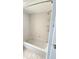 Clean white tiled bathtub and shower with convenient storage racks at 8054 Spring Hill Dr, Spring Hill, FL 34606