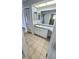 Bathroom featuring a vanity, mirrors, and ceramic tile flooring at 8054 Spring Hill Dr, Spring Hill, FL 34606