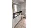 Bathroom with a vanity, large mirror, toilet, and neutral tile flooring at 8054 Spring Hill Dr, Spring Hill, FL 34606