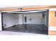 Spacious garage with polished floors, a side door, and a charging outlet at 8054 Spring Hill Dr, Spring Hill, FL 34606