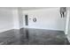 Garage with polished floors, a side door, and a charging outlet at 8054 Spring Hill Dr, Spring Hill, FL 34606