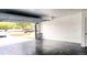 Spacious garage with polished floors, a side door, and an open garage door at 8054 Spring Hill Dr, Spring Hill, FL 34606