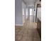 Hallway leading to the front door features ceramic tile flooring and white doors at 8054 Spring Hill Dr, Spring Hill, FL 34606