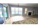 Bright living area with tile flooring, a fireplace, and a view of the sparkling pool, perfect for relaxation at 8054 Spring Hill Dr, Spring Hill, FL 34606