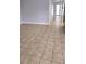 Spacious living room features ceramic tile floors, a light gray color, and base trim at 8054 Spring Hill Dr, Spring Hill, FL 34606