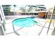 Enclosed screened-in pool with a light colored deck, offering a private oasis at 8054 Spring Hill Dr, Spring Hill, FL 34606