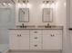 Bathroom features dual sinks, granite countertops, modern lighting and a glass shower at 807 E Ida St # 1, Tampa, FL 33603