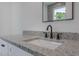 Bathroom featuring granite countertops, modern fixtures and white cabinets at 807 E Ida St # 1, Tampa, FL 33603