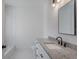 Bathroom featuring granite countertops, modern fixtures and white tile at 807 E Ida St # 1, Tampa, FL 33603