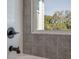 Elegant bathroom featuring patterned tiles and a modern black faucet, complemented by a window view at 807 E Ida St # 1, Tampa, FL 33603