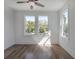 Bright bedroom featuring hardwood floors, white walls, and plenty of natural light at 807 E Ida St # 1, Tampa, FL 33603