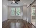 Bright bedroom with hardwood floors and a barn door to the en-suite bathroom at 807 E Ida St # 1, Tampa, FL 33603