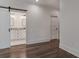 Bedroom with hardwood floors and a barn door to the en-suite bathroom at 807 E Ida St # 1, Tampa, FL 33603