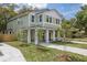 Two-story home featuring a covered front porch, lush lawn, and inviting facade, perfect for comfortable living at 807 E Ida St # 1, Tampa, FL 33603