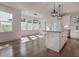 Bright, open kitchen with granite island, pendant lighting, and adjacent dining area with multiple windows at 807 E Ida St # 1, Tampa, FL 33603
