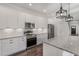 Modern kitchen with granite countertops, stainless steel appliances, and stylish pendant lighting at 807 E Ida St # 1, Tampa, FL 33603