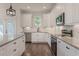 A modern kitchen design featuring white cabinetry, granite counters, and stainless-steel appliances at 807 E Ida St # 1, Tampa, FL 33603
