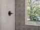 Shower with modern fixtures, white subway tile, and decorative accent tile at 807 E Ida St # 1, Tampa, FL 33603