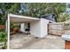 Backyard includes covered area with grill, shed with fence, and paved area at 811 E Flora St, Tampa, FL 33604