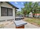 Side view of home with a backyard deck, seating, and view of detached garage at 811 E Flora St, Tampa, FL 33604