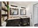 Elegant bathroom with double sinks, stylish mirrors, and vintage-inspired lighting fixtures at 811 E Flora St, Tampa, FL 33604