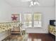 Bedroom with bright natural light, hardwood floors, and adjacent closet/storage space at 811 E Flora St, Tampa, FL 33604