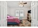 Cozy bedroom with a ceiling fan, bright natural light, and a decorative rug for added charm at 811 E Flora St, Tampa, FL 33604