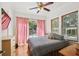 Bedroom featuring hardwood floors, ceiling fan and sliding glass doors to the outside at 811 E Flora St, Tampa, FL 33604