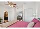 Comfortable bedroom with ceiling fan, double closets and a view to an adjacent room enhance the appeal of this living space at 811 E Flora St, Tampa, FL 33604